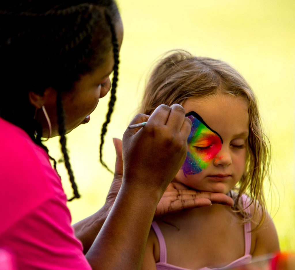 little girl getting her face painted